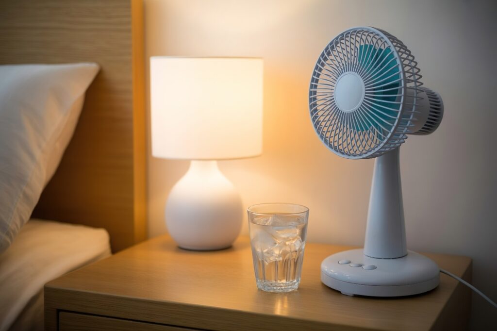 Fan and ice water next to bed.